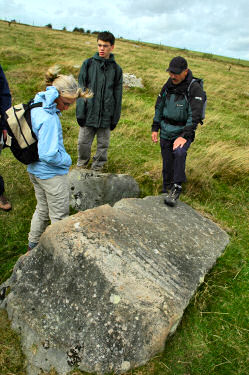 Picture of walkers looking at the stone