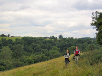Picture of two people walking above a valley