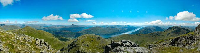 Picture of a panoramic view over hills and lochs from the summit of a Munro