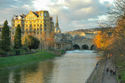 Picture of old buildings and a bridge with houses on it over a river