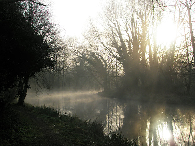 Picture of mist rising over the bend of a canal