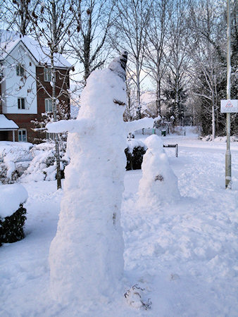Picture of two snowmen, one large male and a smaller female